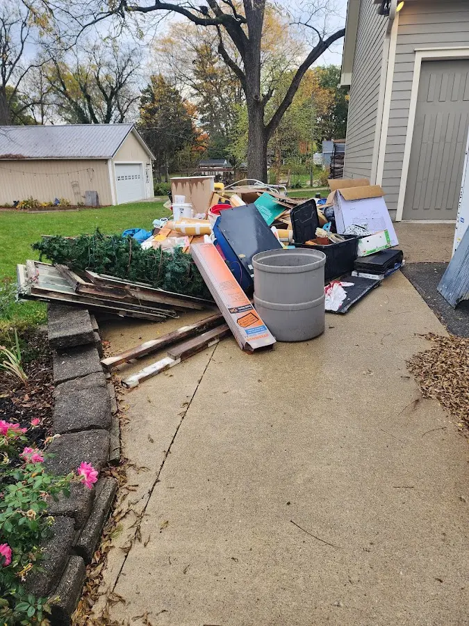 Dumpster being loaded with debris for Roofing Dumpster Rental in Nikiski